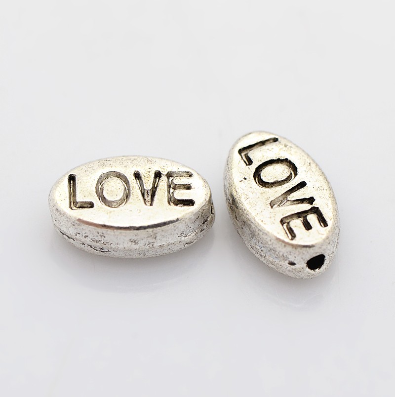 Kovové koráliky LOVE 10x6x4mm, 10ks strieborné